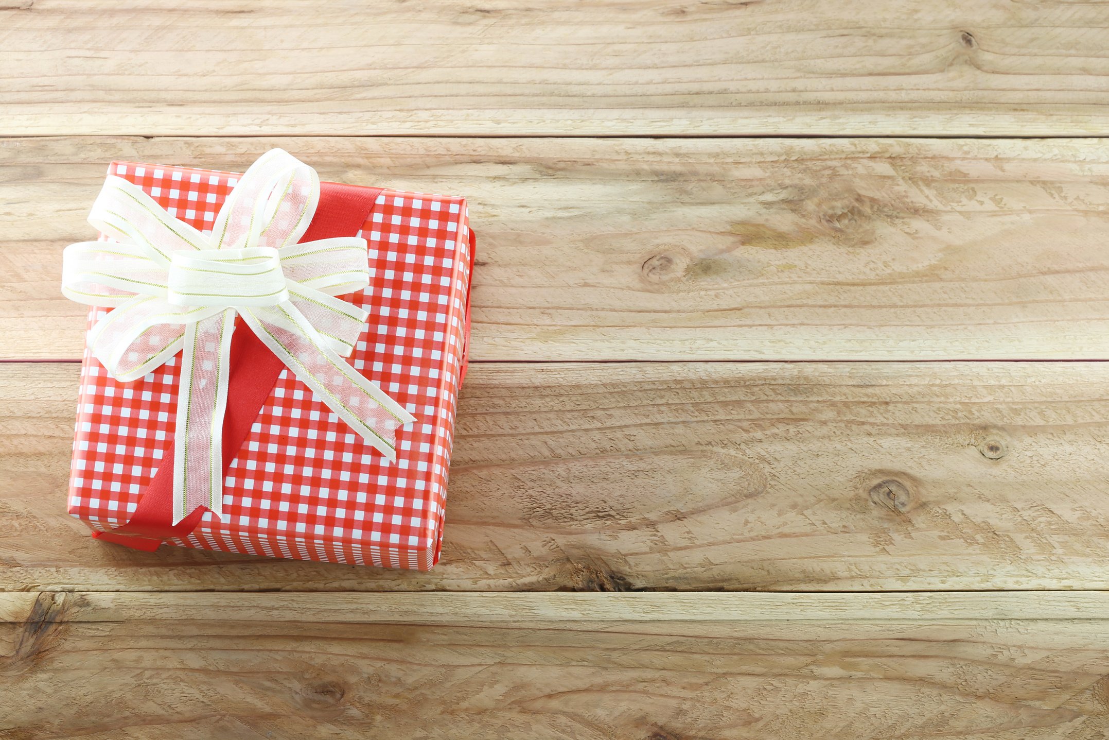 Red gift box on the wooden floor.